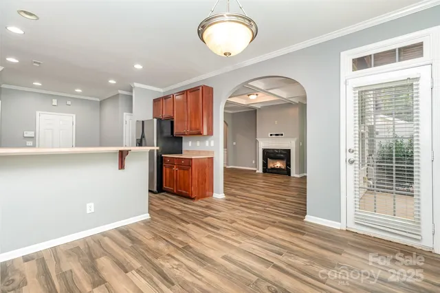 a view of kitchen and hall with wooden floor