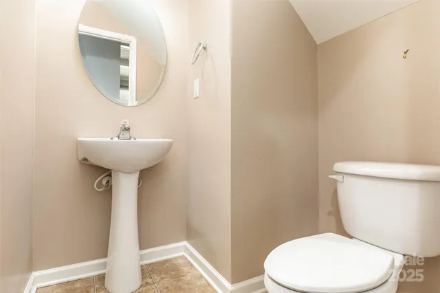 a bathroom with a toilet a sink and a mirror