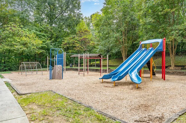 a view of a wooden deck with a slide and table