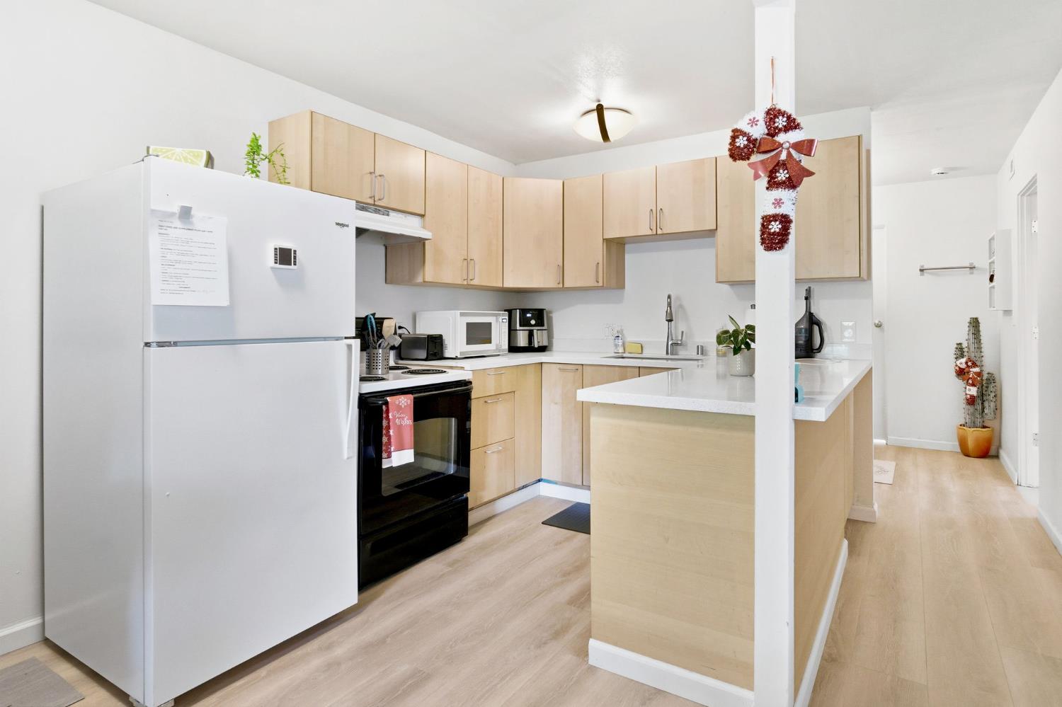240 2nd Street Davis, CA 95616 - Photo 20 of 56 a kitchen with a refrigerator a stove top oven a sink and dishwasher