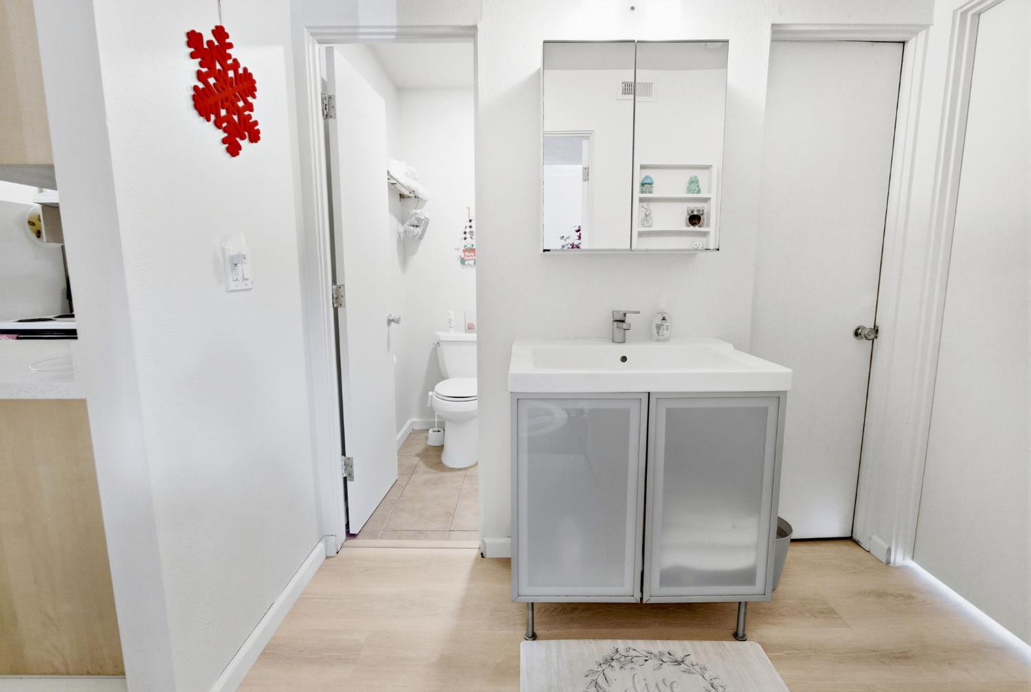 240 2nd Street Davis, CA 95616 - Photo 26 of 56 a bathroom with a sink a mirror and a toilet