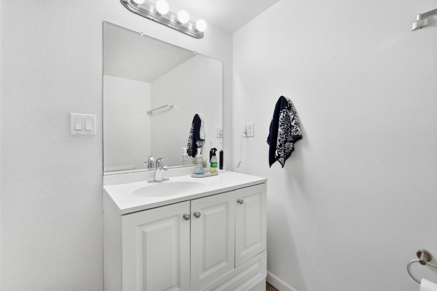 240 2nd Street Davis, CA 95616 - Photo 42 of 56 a bathroom with a sink and mirror with toilet