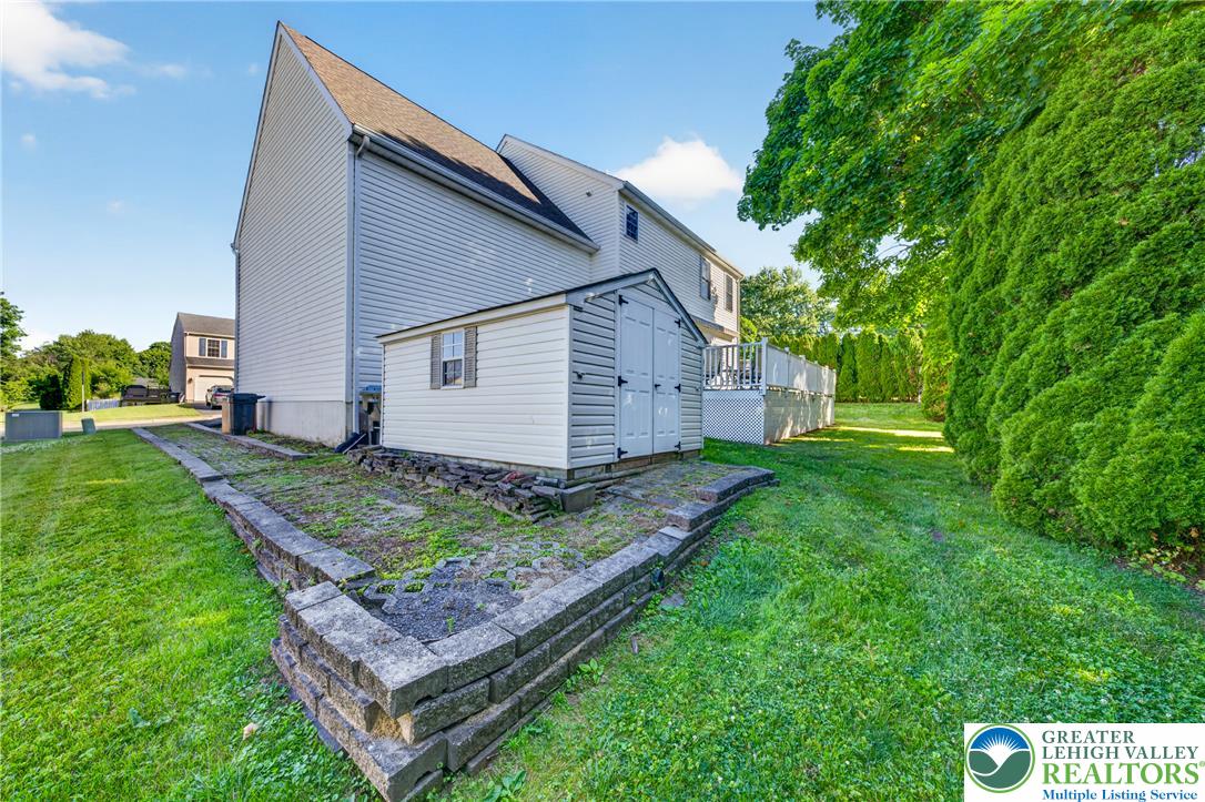 1702 Red Bud Road Quakertown, PA 18951 - Photo 66 of 68 A well-maintained side yard features a practical storage shed and mature privacy landscaping.