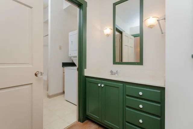 a kitchen with granite countertop white cabinets and a window