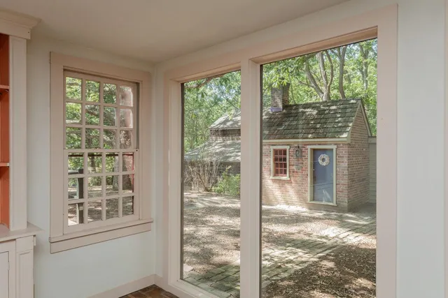 a view of a balcony with wooden floor and door