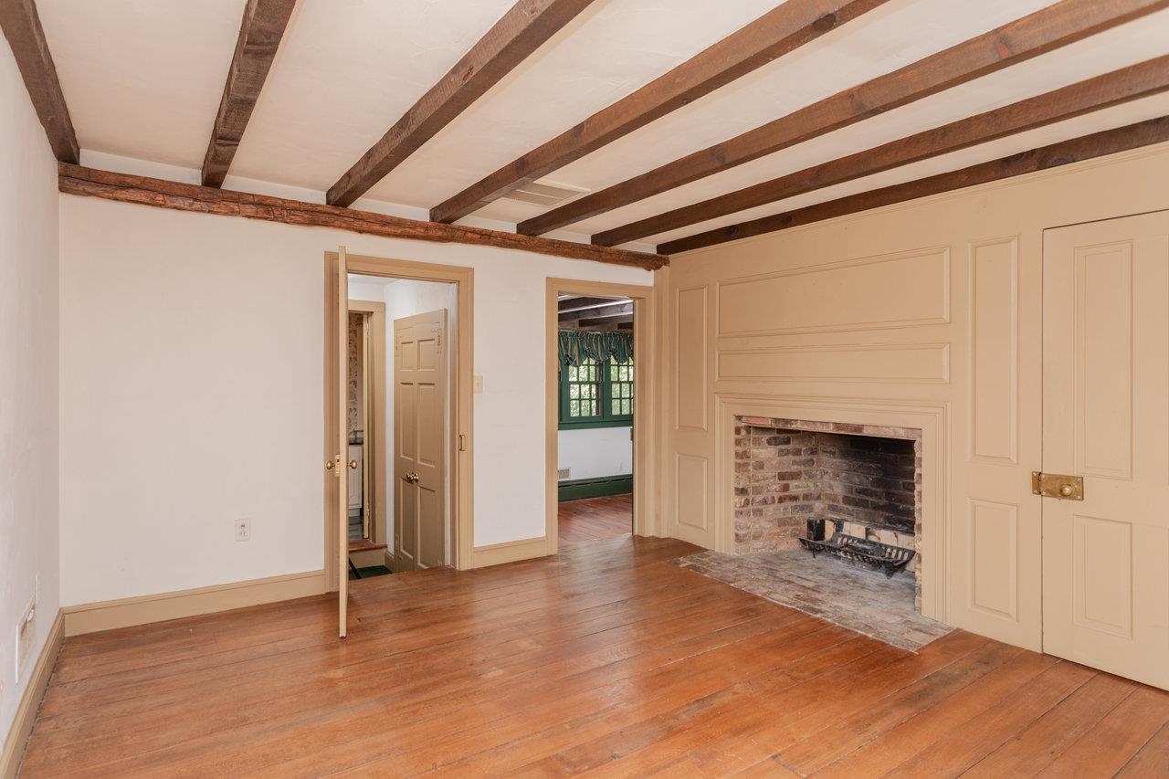 145 Fort Defiance Road Fort Defiance, VA 24437 - Photo 50 of 70 an empty room with wooden floor and a fireplace