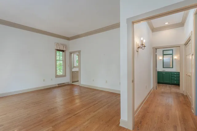 a view of a room with wooden floor and window