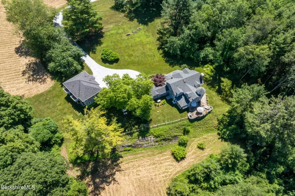 an aerial view of a house with a yard