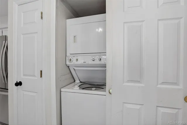 a kitchen with stainless steel appliances granite countertop a sink and a refrigerator