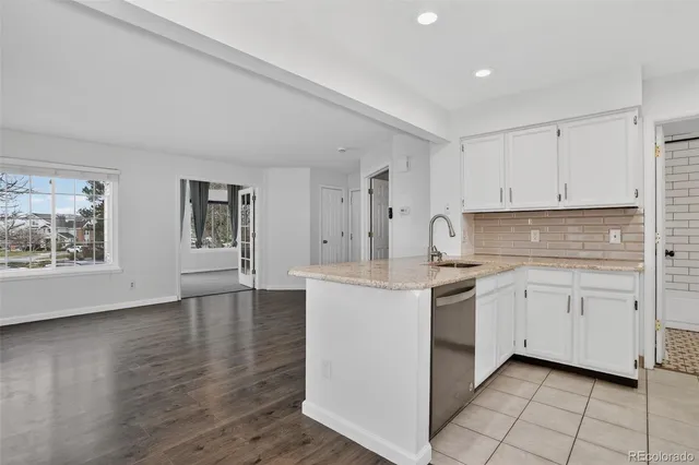 a kitchen with a refrigerator sink and cabinets