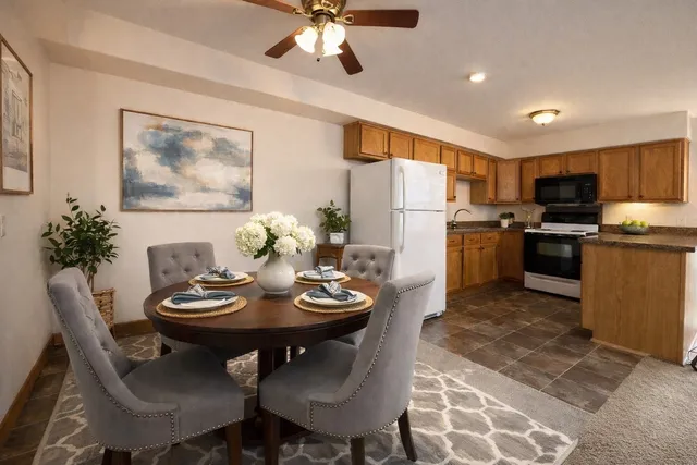 a view of a dining room with furniture and a kitchen