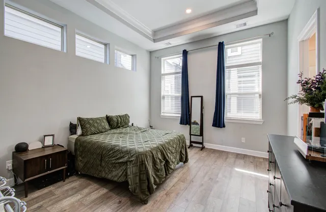 a bedroom with a bed and windows