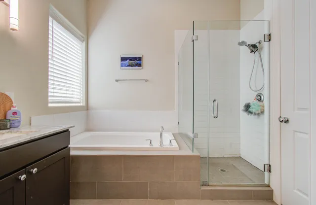 a bathroom with a bathtub and a shower
