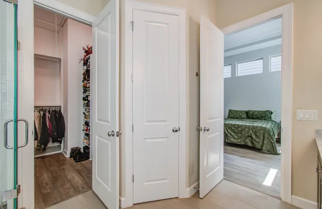 a view of a walk in closet and bathroom