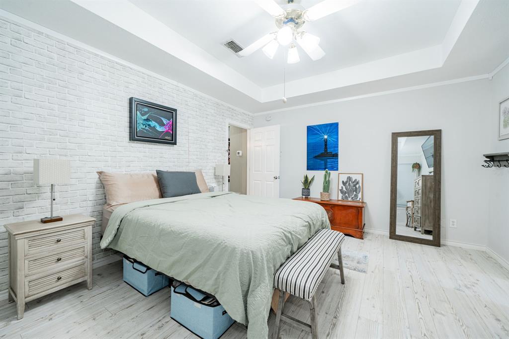 508 Tishomingo Road Waxahachie, TX 75165 - Photo 16 of 26 a bedroom with a bed and a chandelier