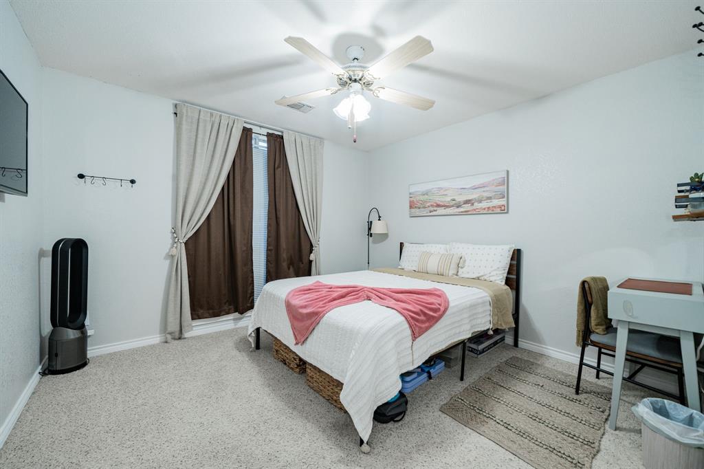 508 Tishomingo Road Waxahachie, TX 75165 - Photo 19 of 26 a bed room with a bed and a chandelier