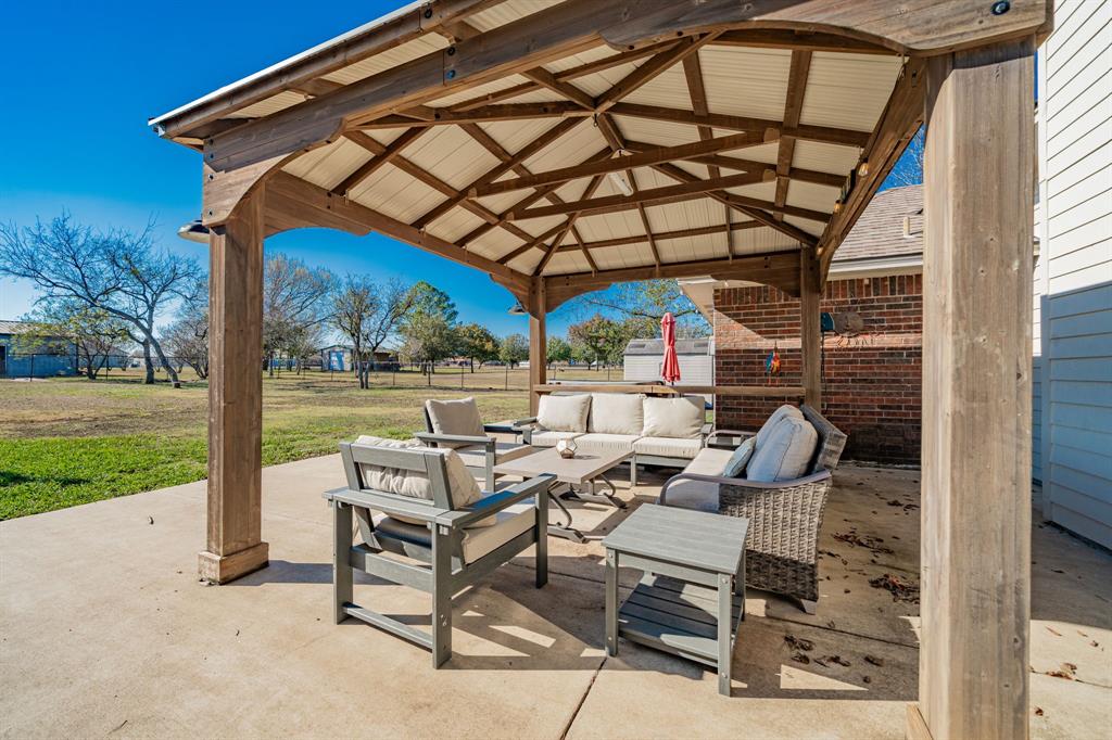 508 Tishomingo Road Waxahachie, TX 75165 - Photo 22 of 26 a view of a patio with a table and chairs under an umbrella