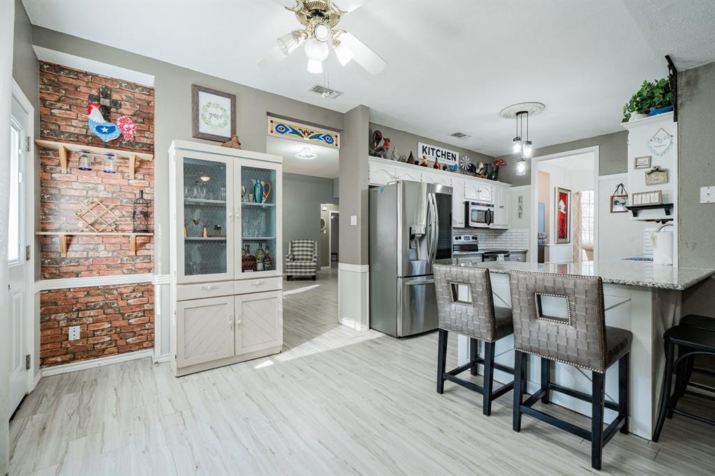 508 Tishomingo Road Waxahachie, TX 75165 - Photo 6 of 26 a view of a kitchen with furniture and wooden floor