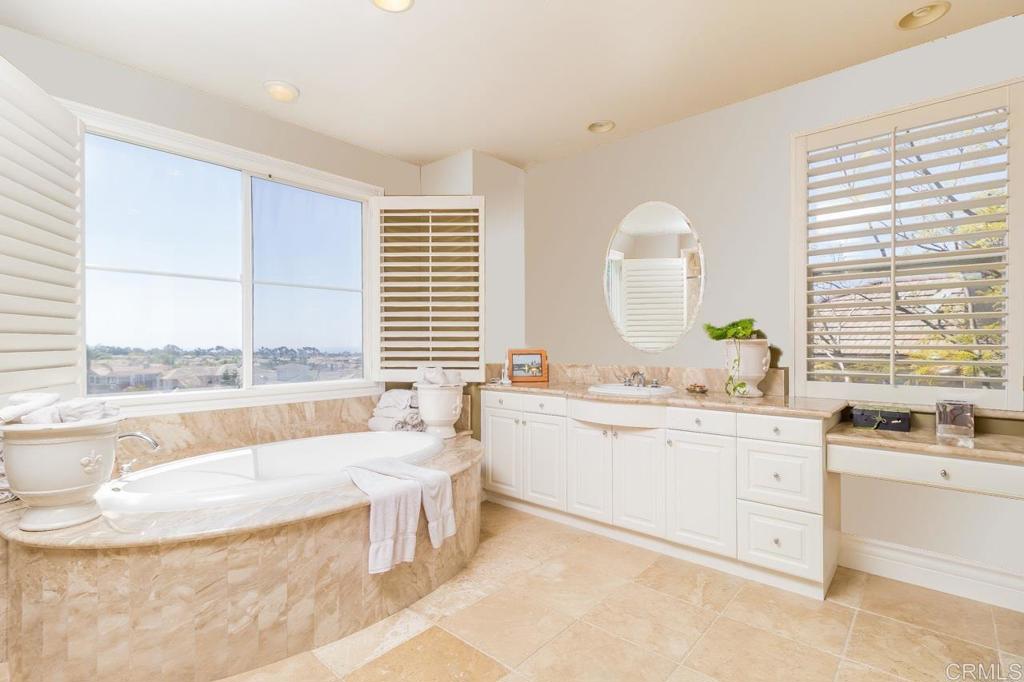 1499 Paseo De Las Flores Encinitas, CA 92024 - Photo 23 of 30 a bathroom with a granite countertop sink and a bathtub