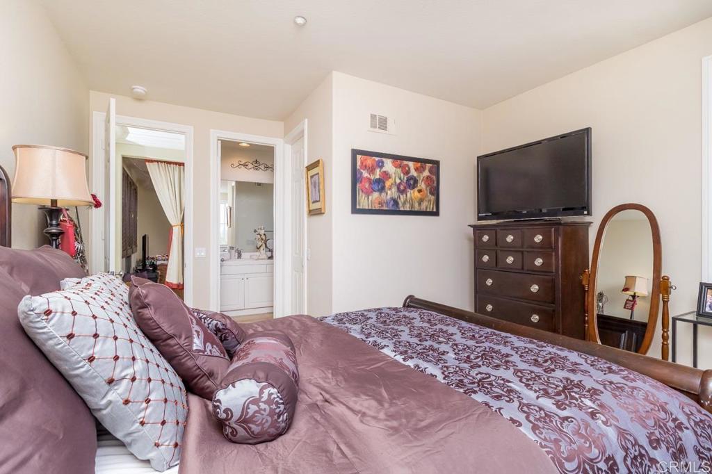 1499 Paseo De Las Flores Encinitas, CA 92024 - Photo 25 of 30 a bedroom with a bed and a flat screen tv