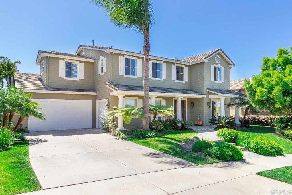 1499 Paseo De Las Flores Encinitas, CA 92024 - Photo 3 of 30 a front view of a house with a garden and plants