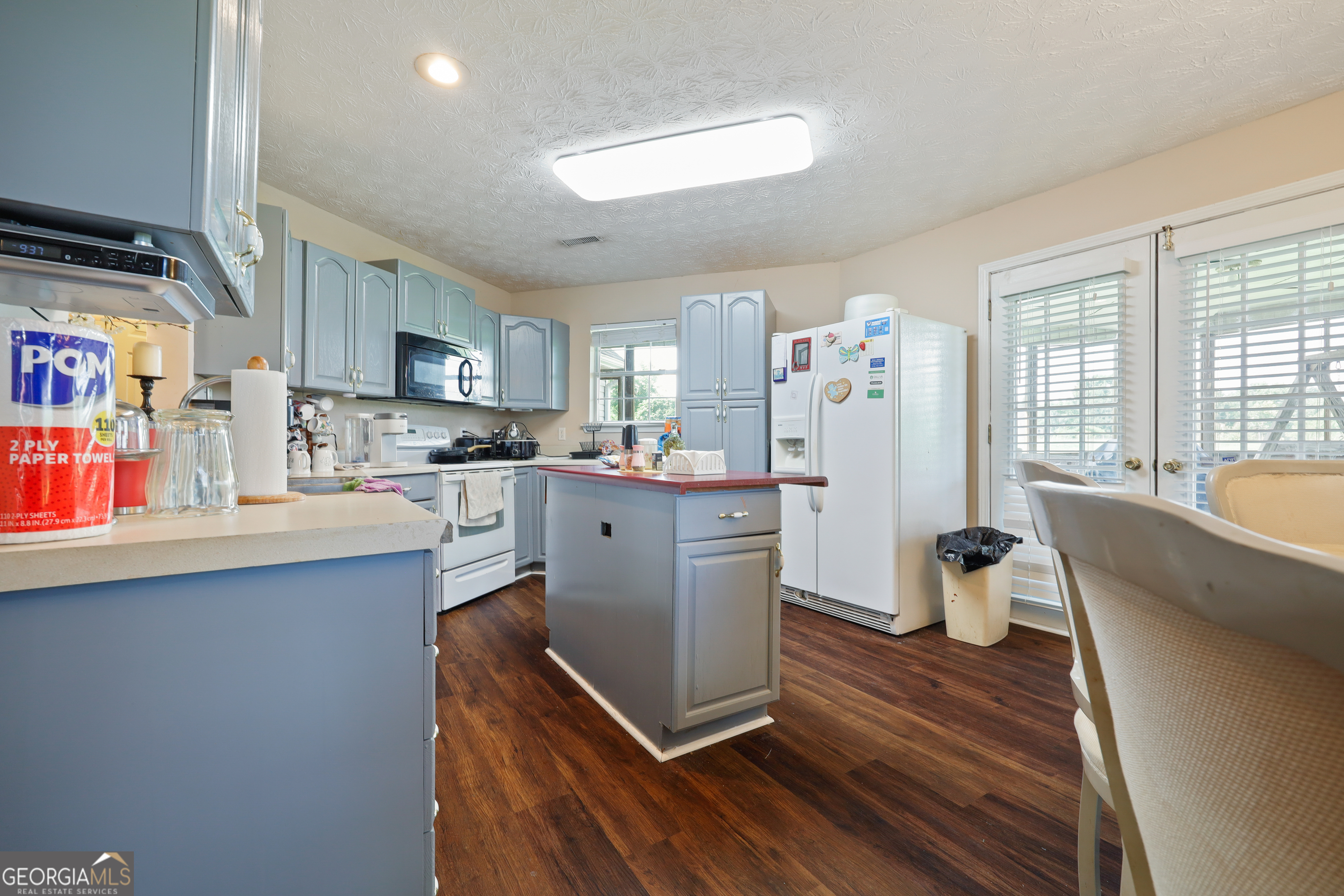 2433 Bear Creek Road Statham, GA 30666 - Photo 44 of 58 a kitchen with stainless steel appliances granite countertop a refrigerator sink and wooden cabinets