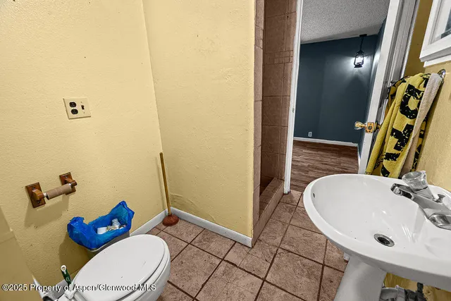 a bathroom with a sink mirror vanity and toilet