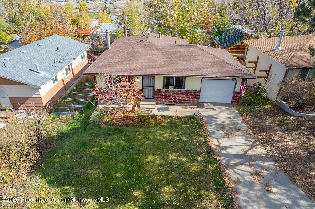 1159 Barclay Street Craig, CO 81625 - Photo 42 of 45 a aerial view of a house with table and chairs under an umbrella
