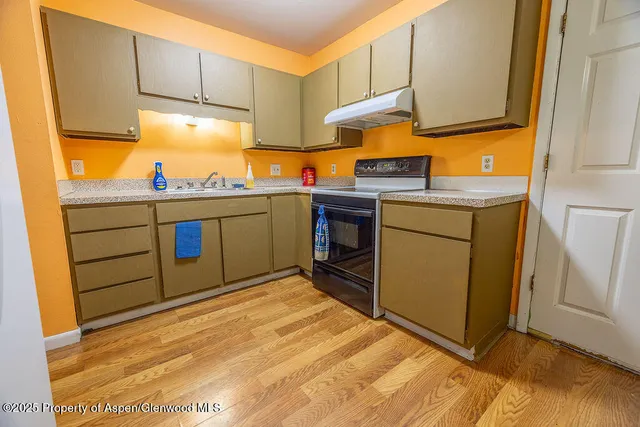 a kitchen with appliances cabinets and a sink