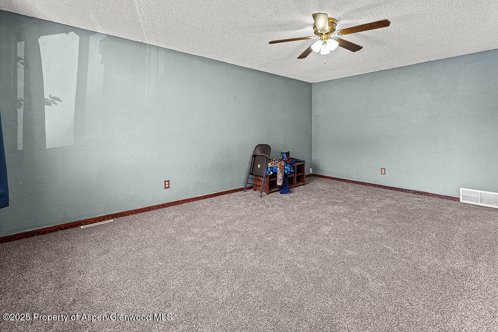 1159 Barclay Street Craig, CO 81625 - Photo 8 of 45 a view of a room with gym equipment and a ceiling fan