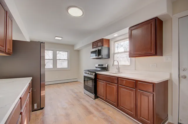 a kitchen with a sink stove and microwave
