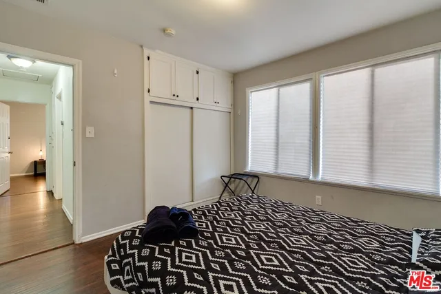 a view of a room with wooden floor and windows