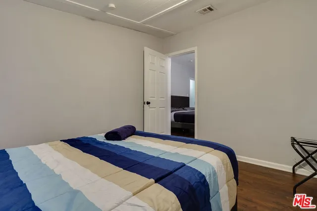 a bedroom with a bed and a potted plant