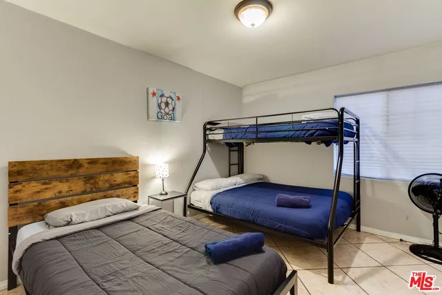 a bedroom with a bed and a chair