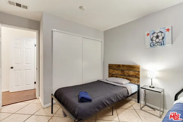 a bedroom with a bed and a cabinets