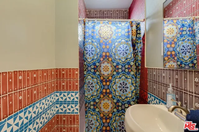a bathroom with a toilet and shower curtain