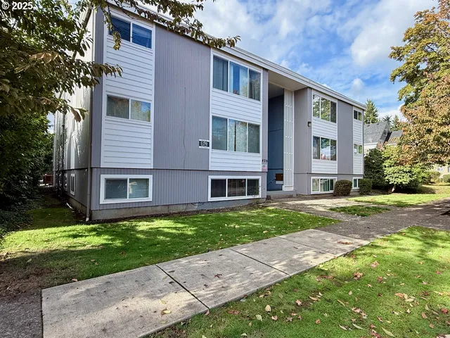a brick house that is sitting in the grass