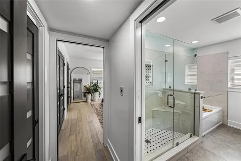 an aerial view of ocean and residential building with outdoor space