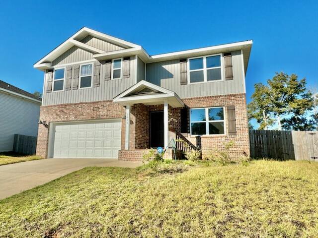 5414 Merlin Milton, FL 32583 - Photo 2 of 35 a front view of a house with a yard and garage