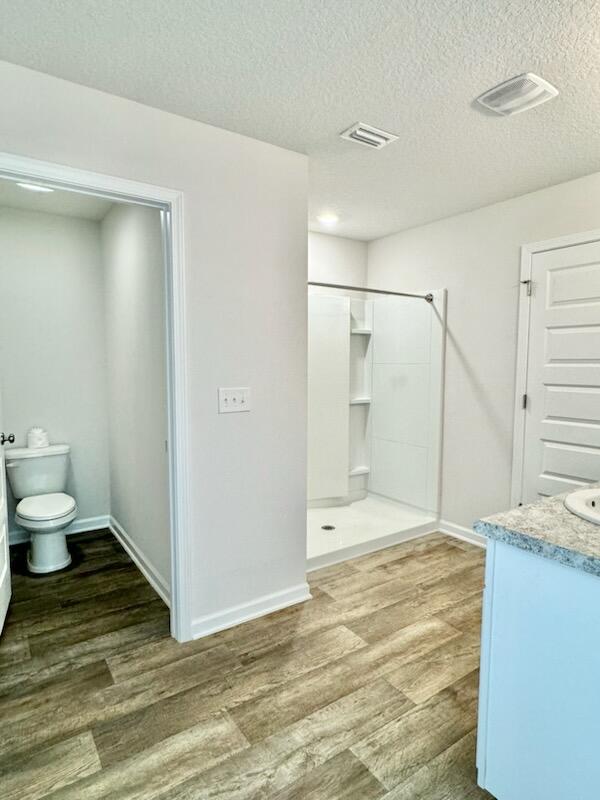 5414 Merlin Milton, FL 32583 - Photo 21 of 35 a bathroom with a granite countertop sink a toilet and shower
