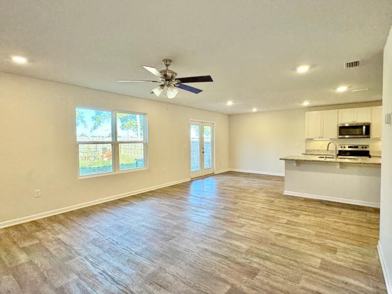 5414 Merlin Milton, FL 32583 - Photo 5 of 35 a view of an empty room with kitchen and window
