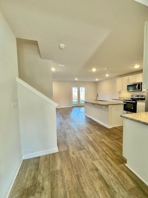 5414 Merlin Milton, FL 32583 - Photo 7 of 35 a view of kitchen with kitchen island a sink wooden floor and stainless steel appliances