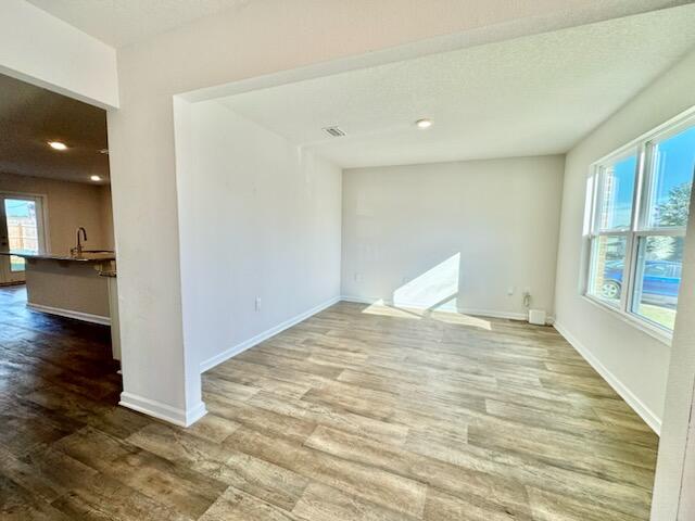 5414 Merlin Milton, FL 32583 - Photo 9 of 35 a view of empty room with wooden floor and windows