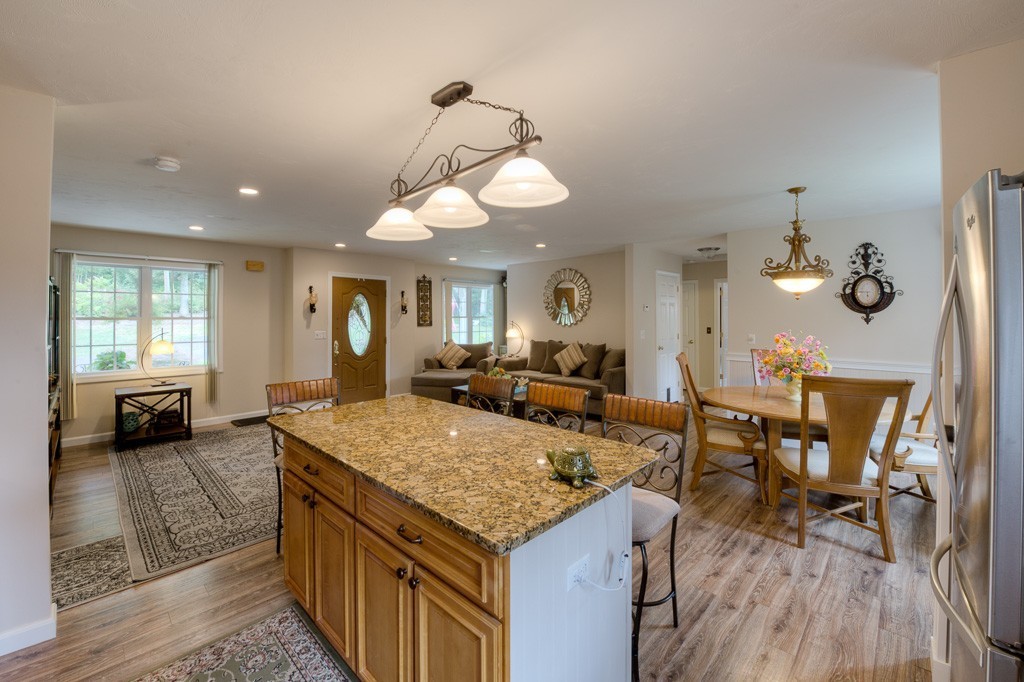 85 Old Reed Road Monson, MA 01057 - Photo 3 of 30 a view of a dining room and livingroom with furniture wooden floor a chandelier