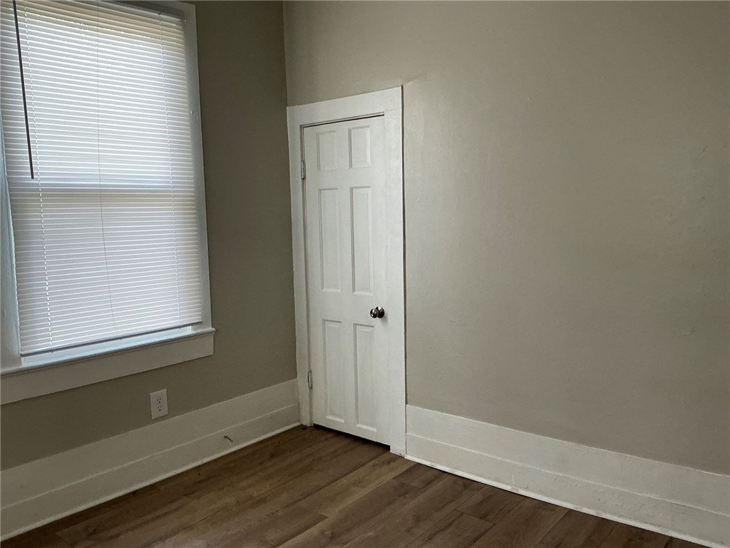 504 Caughlin Avenue Anderson, SC 29624 - Photo 8 of 15 Hardwood-style flooring and a window with blinds define this tranquil living space.