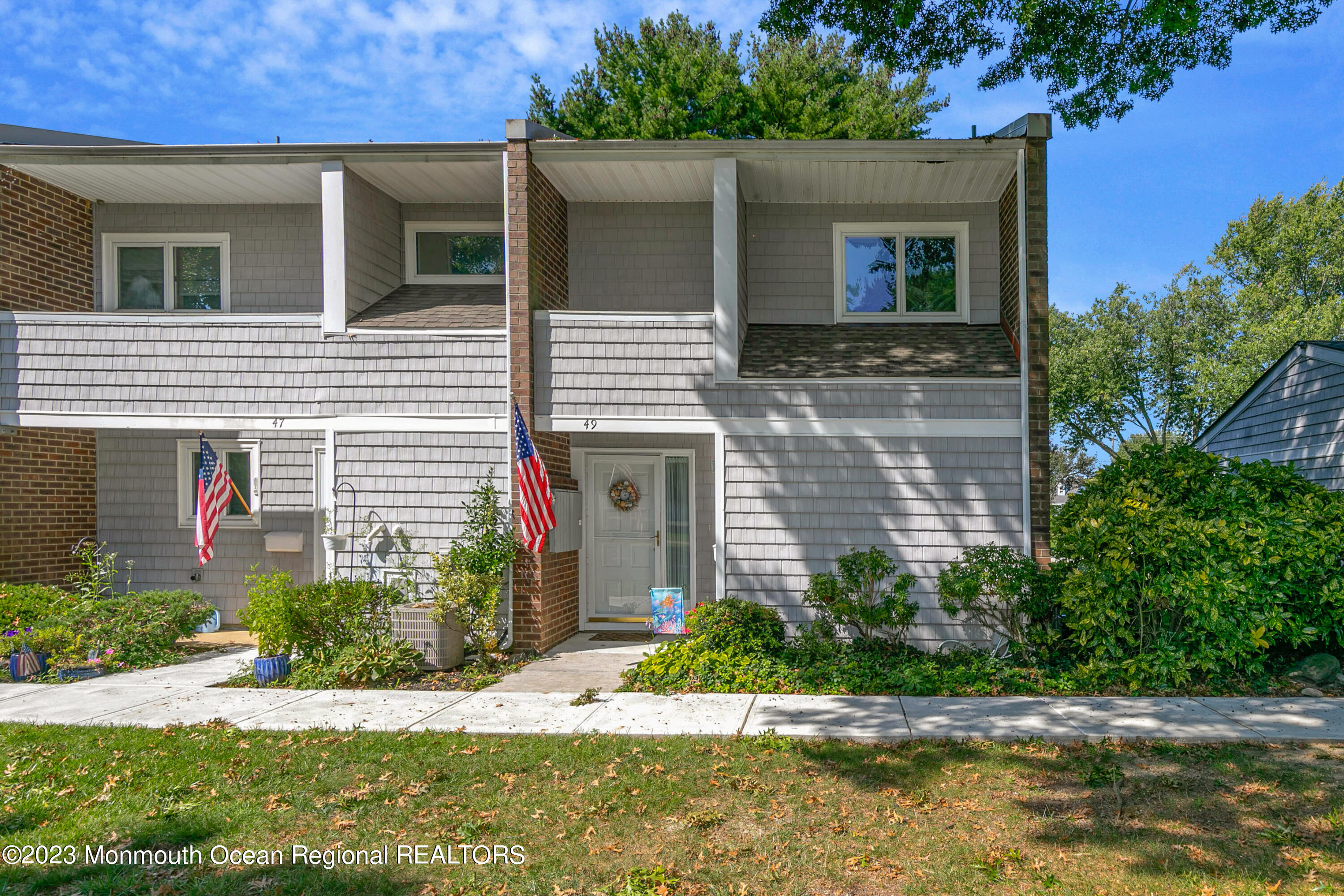 49 Locust Way Spring Lake Heights, NJ 07762 - Photo 2 of 34 a front view of a house with a yard and potted plants
