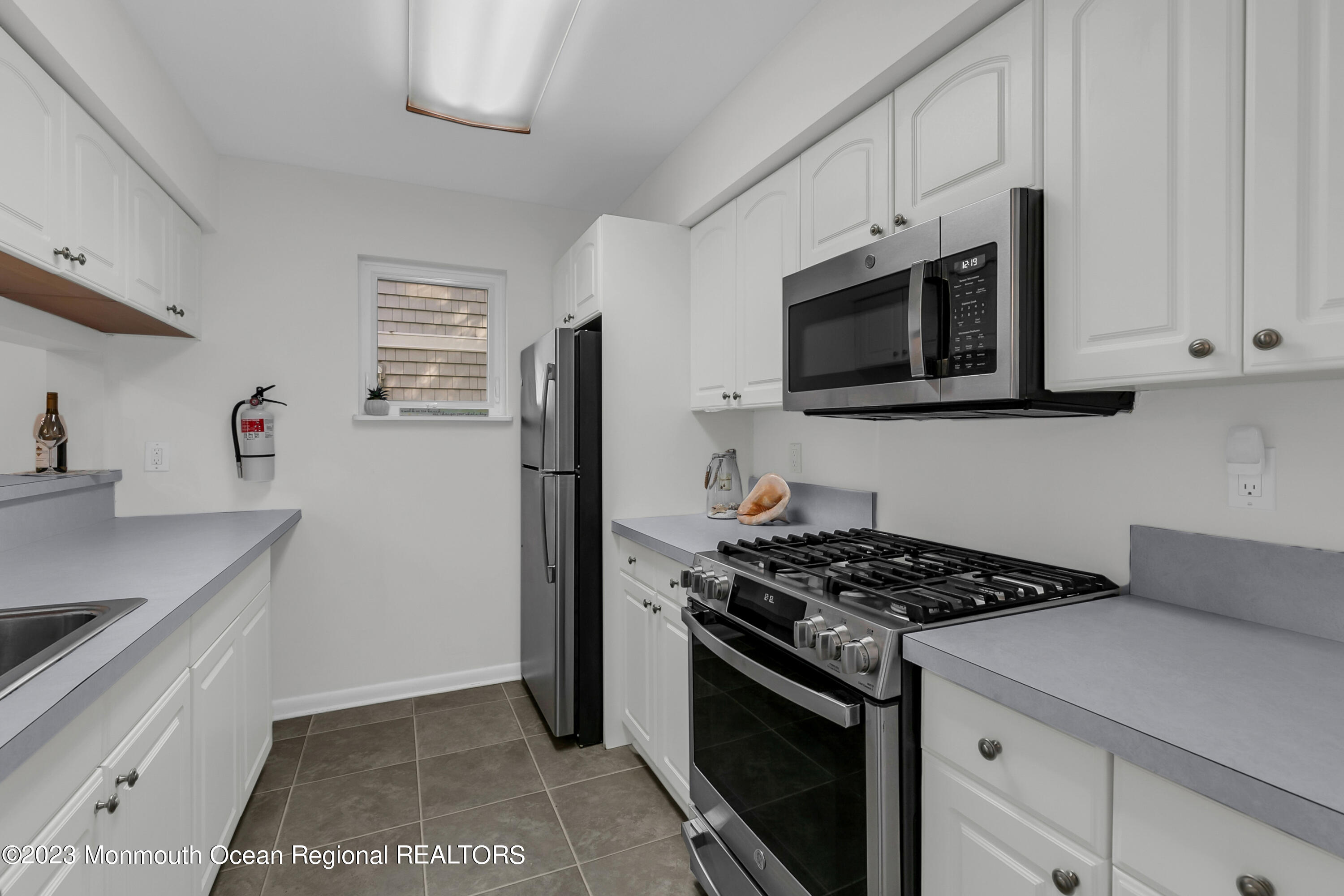 49 Locust Way Spring Lake Heights, NJ 07762 - Photo 9 of 34 a kitchen with cabinets stainless steel appliances and a sink