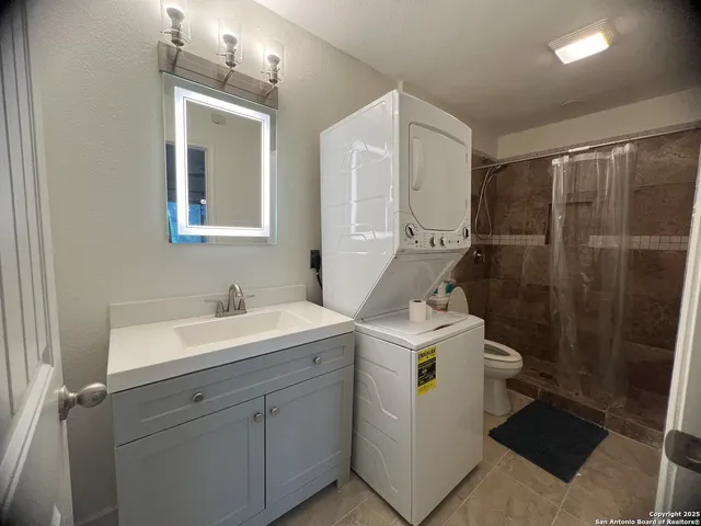 a view of bathroom with a sink mirror and toilet