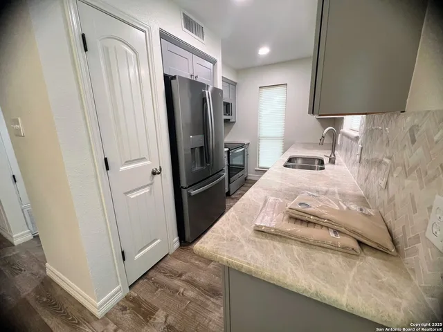 a bedroom with a bed and a refrigerator