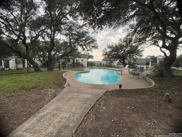 a view of a swimming pool with a yard